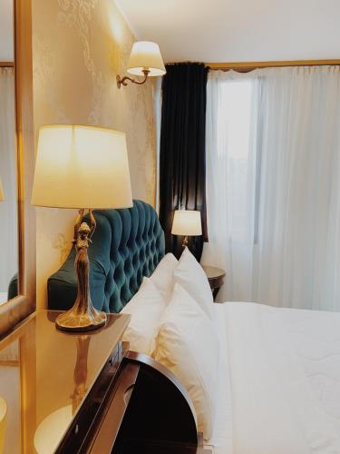 a bedroom with a bed and a table with a lamp at Five Seasons in Nafplio