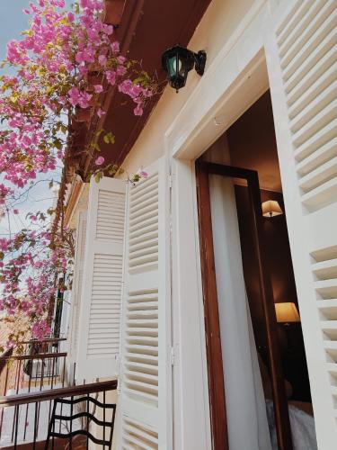 a door to a balcony with pink flowers at Five Seasons in Nafplio