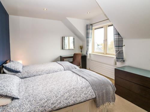 a bedroom with a bed and a window at Ring of Kerry Golf Club Cottage in Kenmare