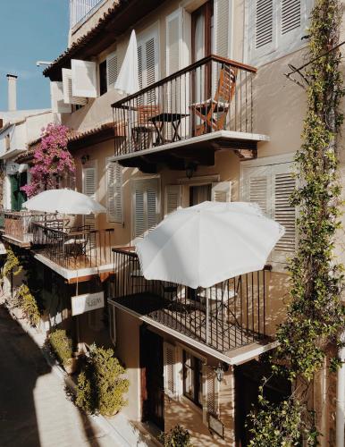 a white umbrella sitting on the balcony of a building at Five Seasons in Nafplio