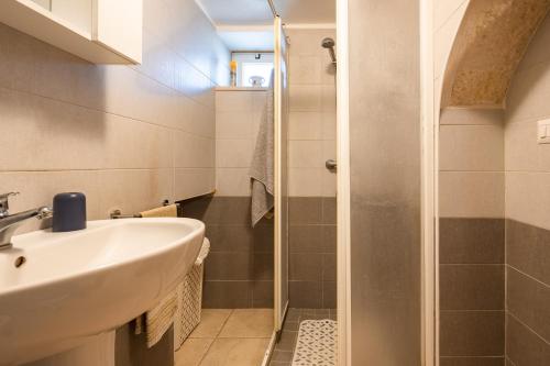 a bathroom with a sink and a shower at Trulli da Tommaso - Martina Franca in Martina Franca