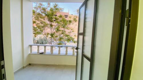 an open door with a view of a balcony at Petra Olive House in Wadi Musa