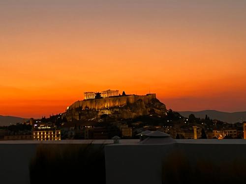 a view of the acropolis at sunset at Ma Maison Acropolis Mansion, Penthouse Suite No7 with exclusive roof garden, Ultra High Speed Internet 500 Mbps, 500 meters from Acropolis in Athens