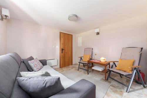 a living room with a couch and chairs and a table at Chalet Trzinka - Triglav National Park in Goreljek