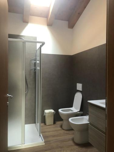 a bathroom with a toilet and a glass shower at al poset in Paderno del Grappa