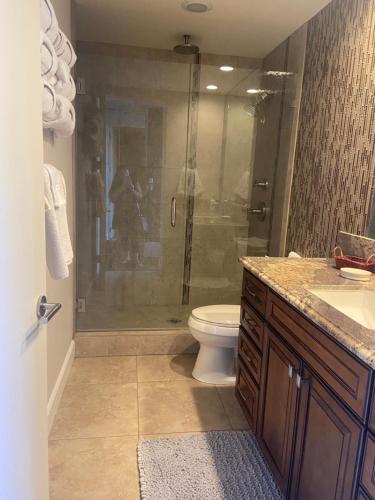 a bathroom with a shower with a toilet and a sink at Large Creekside Studio at Shadow Mountain Resort and Club in Palm Desert