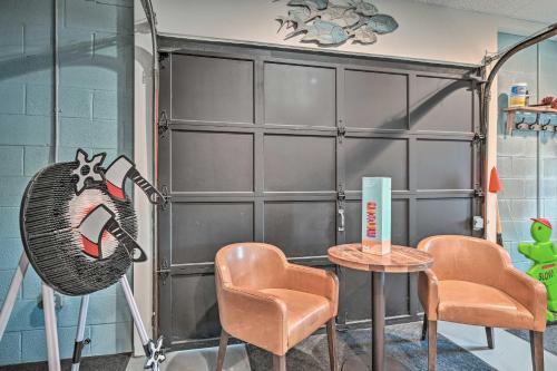 a room with chairs and a large garage door at Lake Luzerne Home with Fire Pit on Hudson River in Lake Luzerne