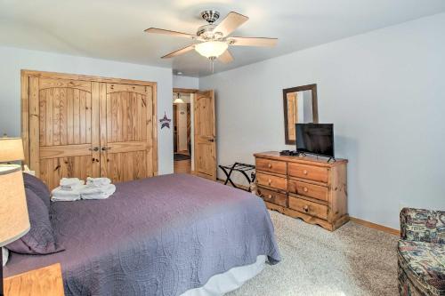 a bedroom with a bed and a tv and a dresser at Fire Pit, Fenced Yard Overgaard Cabin Near Hiking in Overgaard