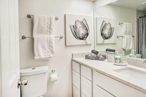 a bathroom with a toilet and a sink and a mirror at Chic Phoenix Condo Pool Access, Close to Hiking in Phoenix