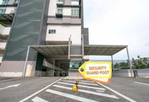 a caution sign in a parking lot in front of a building at Azin Ramli Studio in Seri Kembangan