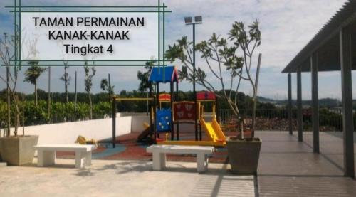 a playground with a slide at a park at Azin Ramli Studio in Seri Kembangan