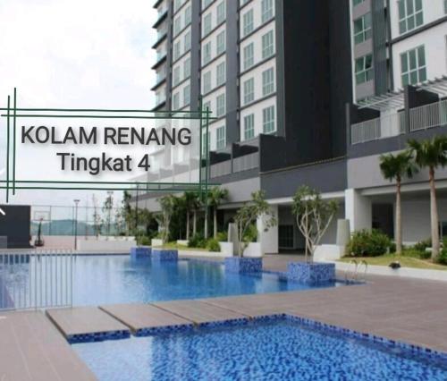 a swimming pool in front of a building at Azin Ramli Studio in Seri Kembangan