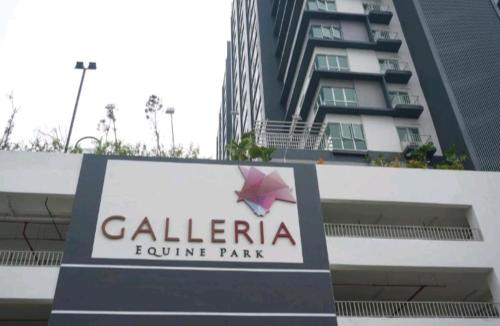 a sign for a hotel in front of a building at Azin Ramli Studio in Seri Kembangan
