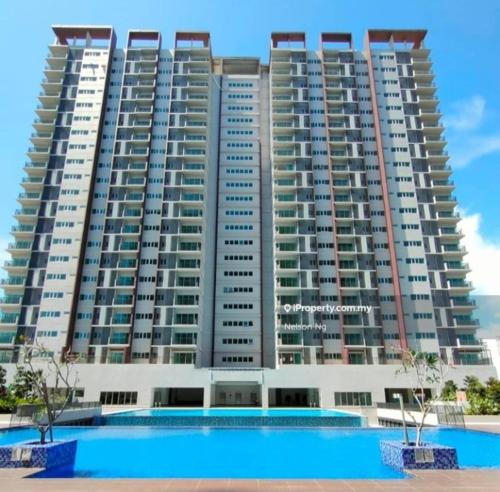 a large apartment building with a swimming pool in front of it at Azin Ramli Studio in Seri Kembangan