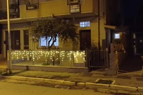 a fence with christmas lights in front of a building at Soggiorno a 5 stelle, tra mare, cultura e natura in Cattolica