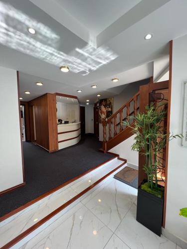 a large room with a staircase and a lobby at Hotel Boutique Quinta Camacho in Bogotá