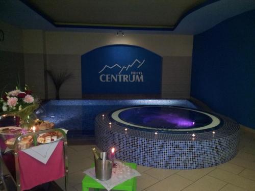 a jacuzzi tub in a room with a sign at Hotel Centrum Harrachov in Harrachov