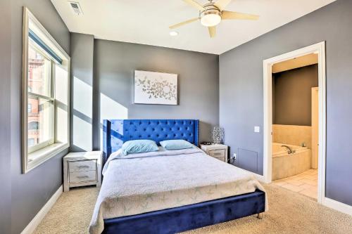 a blue bedroom with a bed and a window at Historical Apt in Dtwn Omaha - Pets Welcome! in Omaha