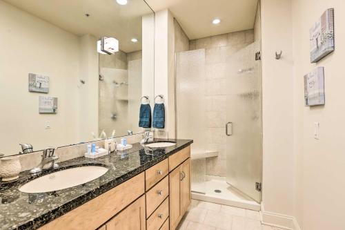 a bathroom with two sinks and a shower at Historical Apt in Dtwn Omaha - Pets Welcome! in Omaha