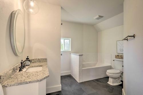 a bathroom with a sink and a toilet and a tub at Modern Cottage Escape On Table Rock Lake! in Golden