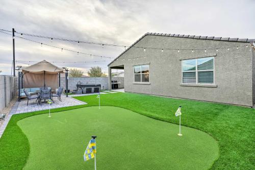 a yard with a putting green and a house at New-Build Glendale Home with Hot Tub and Putting Green in Glendale