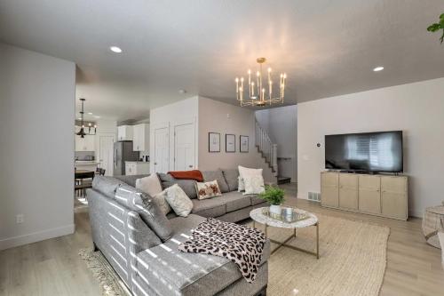 a living room with a couch and a tv at Lovely Vineyard Getaway Less Than 1 Mi to Utah Lake! in Vineyard