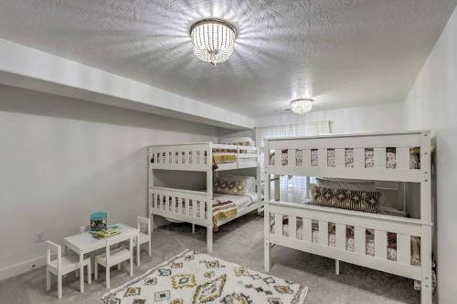 a room with two bunk beds and a table at Lovely Vineyard Getaway Less Than 1 Mi to Utah Lake! in Vineyard