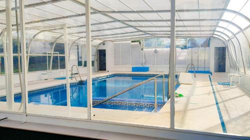 a swimming pool in a building with an indoor pool at Laguna Beach Paradise - Alojamientos La Torre in Torrox Costa