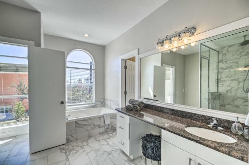 a bathroom with two sinks and a shower and a tub at Modern Houston Gem about Walk to Minute Maid Park in Houston