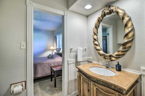 een badkamer met een wastafel, een spiegel en een bed bij Seabrook Home with Central AandC, Gas Grill and Patio! in Seabrook