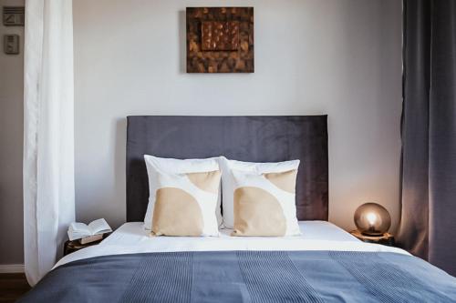 a bedroom with a large bed with white pillows at TurnKey I King George Square Studio in Prague