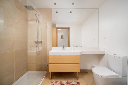 a bathroom with a sink and a toilet and a shower at Terraços do Rio by CORAL in Portimão