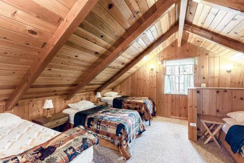 a attic room with three beds in a room at Lancaster Cabin in Bass Lake
