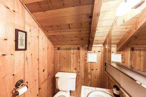 a wooden bathroom with a toilet and a sink at Lancaster Cabin in Bass Lake
