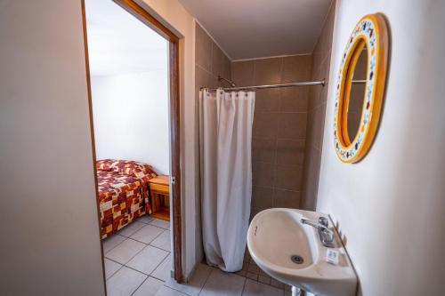 a bathroom with a sink and a shower at Hotel Meson de Isabel in Querétaro