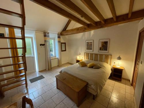 a bedroom with a large bed in a room at LE GOLURET Chambres & Table d'hôtes - Espace Bien Être in Couvignon