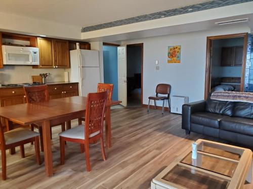 eine Küche und ein Wohnzimmer mit einem Tisch und einem Sofa in der Unterkunft Home of Thousand Islands in Gananoque