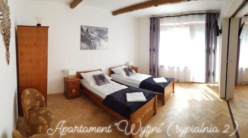 Posteľ alebo postele v izbe v ubytovaní Apartamenty MOŁS Zakopane
