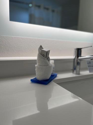 a stuffed animal sitting on a blue towel in front of a sink at Holiday Inn Express Hotel & Suites Lake Elsinore by IHG in Lake Elsinore