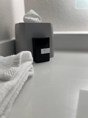 a black box with a white towel next to a bed at Holiday Inn Express Hotel & Suites Lake Elsinore by IHG in Lake Elsinore