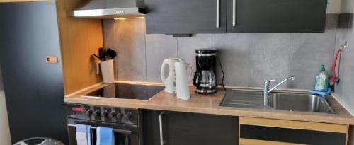 a kitchen with a sink and a counter top at UnterwegsZuHause in Solingen