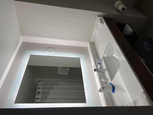 a bathroom with a mirror and a sink in a room at Holiday Inn Express Hotel & Suites Lake Elsinore by IHG in Lake Elsinore