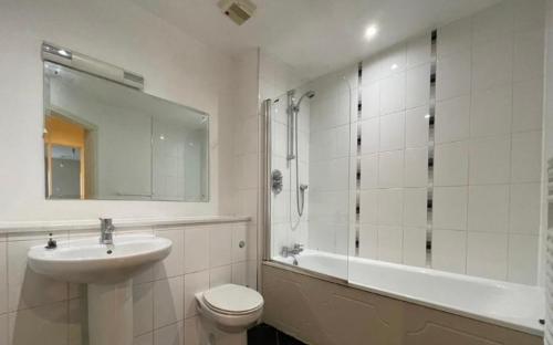 a bathroom with a sink and a toilet and a shower at stylish two bed in the heart of the city in Birmingham