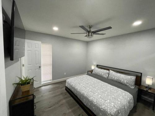 1 dormitorio con 1 cama y ventilador de techo en Breathtaking & Renovated Tampa Heated Pool House, en Tampa