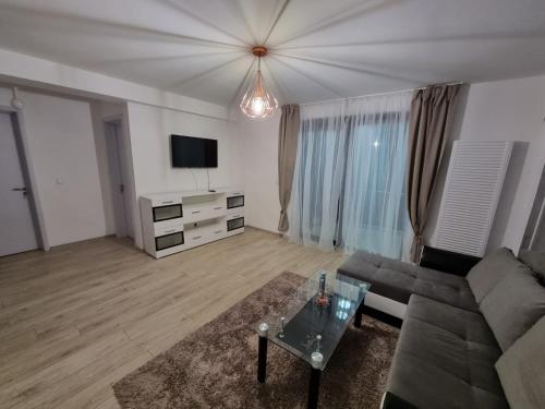 a living room with a couch and a tv at DREAMS ESCAPE in Craiova