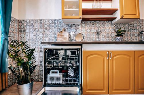 a kitchen with an open dishwasher in the middle at TurnKey I Studio by City Mall in Prague