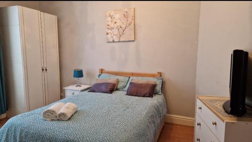 a bedroom with a bed with a blue comforter at Spacious Double Room in Anfield in Liverpool