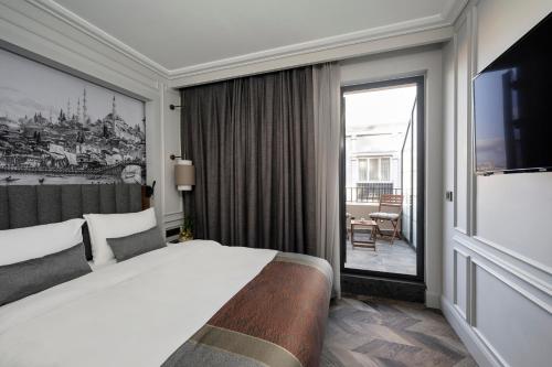 a hotel room with a bed and a large window at Livro Hotel in Istanbul