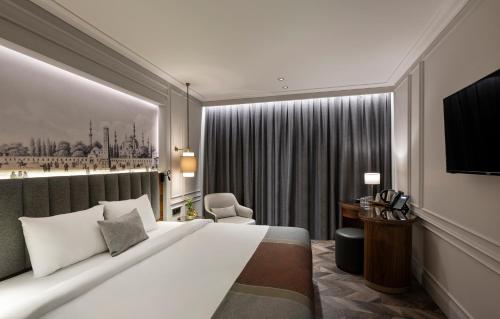 a hotel room with a large bed and a desk at Livro Hotel in Istanbul