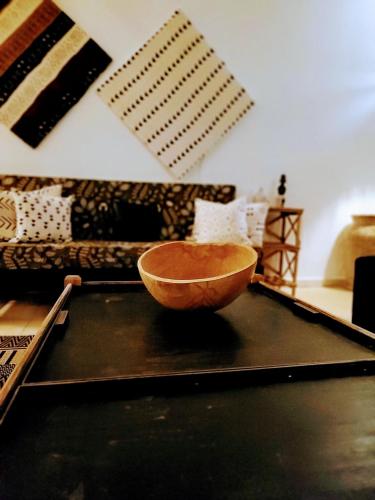 a bowl sitting on a table in a living room at Ginger Villa Somone in Somone